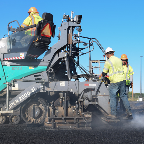 workers flattening asphalt