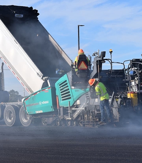 workers flattening pavement